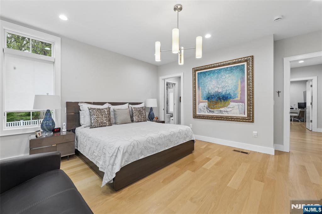 31 Engleside Street Cresskill, NJ 07626 - Photo 18 of 49 a spacious bedroom with a bed and a chandelier