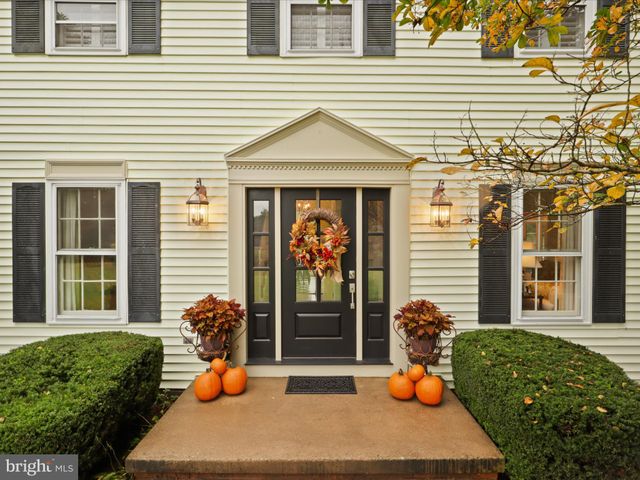 a kitchen with stainless steel appliances granite countertop a refrigerator a stove a microwave oven with a dining table and chairs