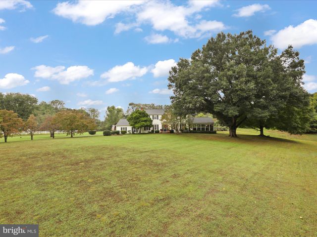 a kitchen with a sink a stove and chairs