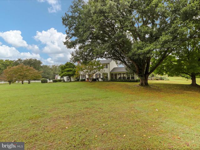 a kitchen with stainless steel appliances kitchen island granite countertop a sink a stove top oven and cabinets