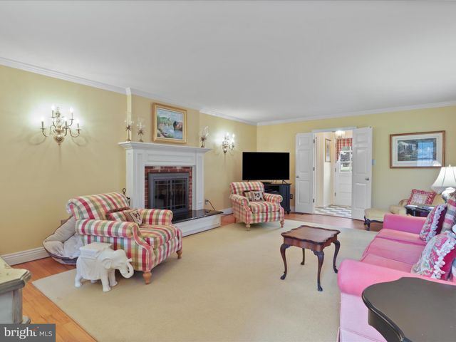 a bedroom with a bed and a flat tv screen on dresser