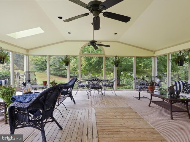 a bathroom with a granite countertop double vanity sink a mirror and a toilet