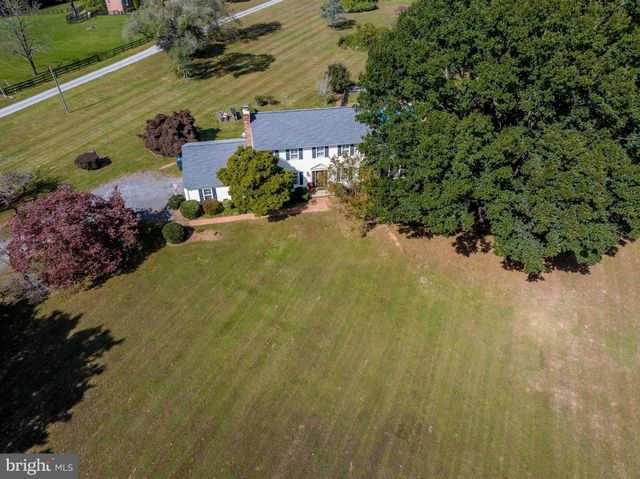 an aerial view of a house with a yard and lake view