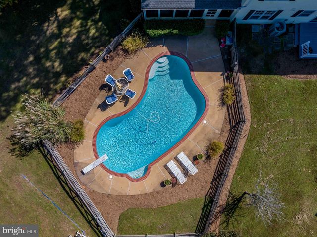 an aerial view of a house with a backyard