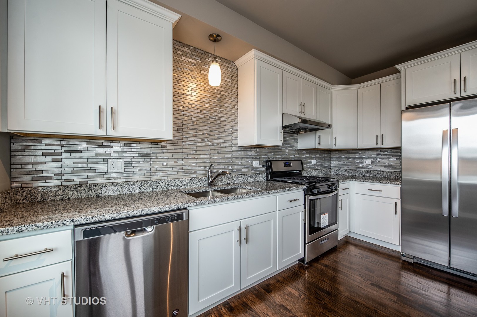 2606 South Halsted Street, Unit 2N Chicago, IL 60608 - Photo 4 of 10 a kitchen with stainless steel appliances granite countertop a sink stove and refrigerator