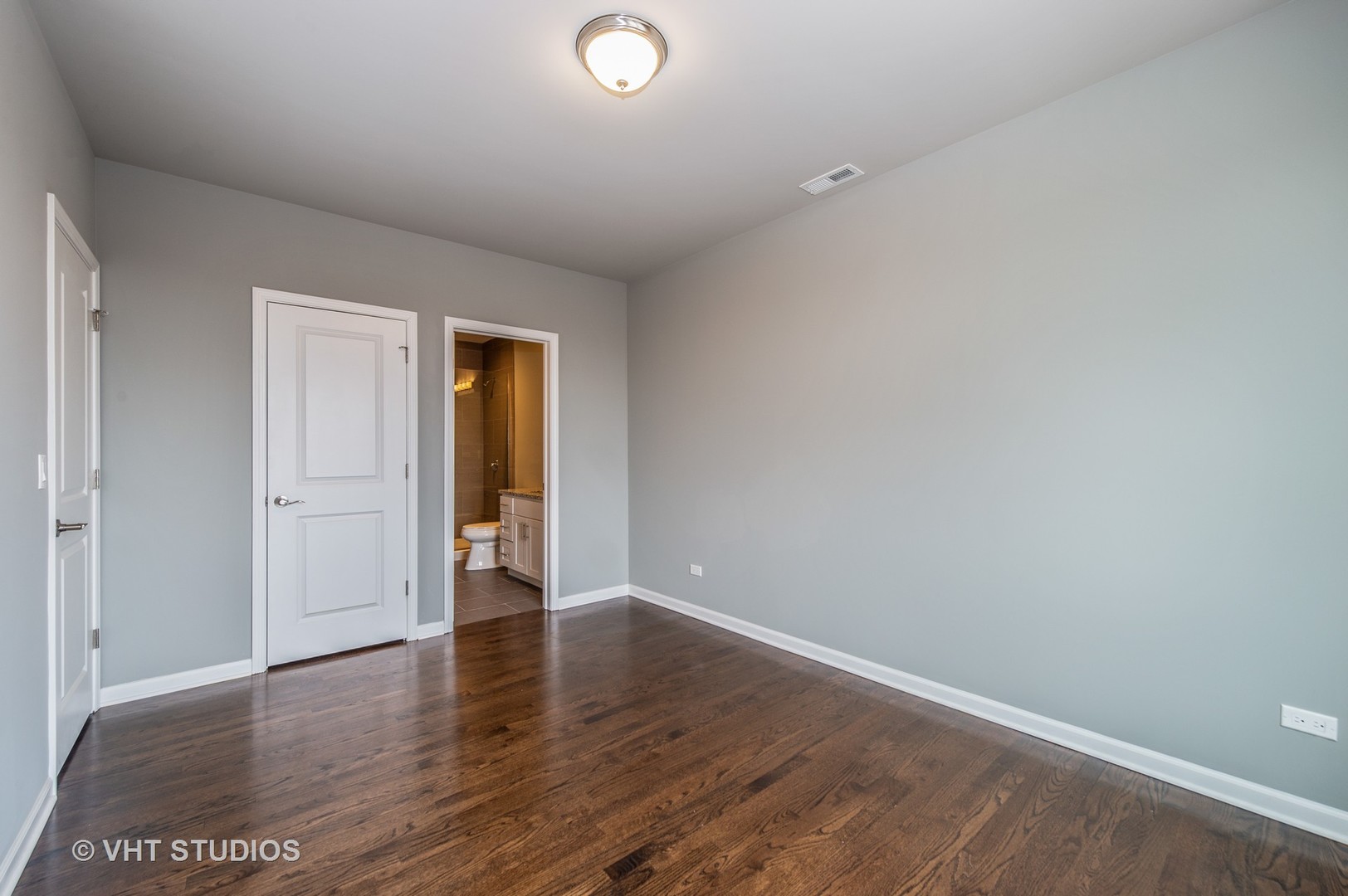 2606 South Halsted Street, Unit 2N Chicago, IL 60608 - Photo 5 of 10 a view of an empty room with wooden floor and closet
