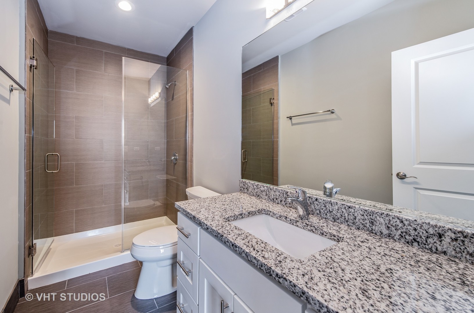 2606 South Halsted Street, Unit 2N Chicago, IL 60608 - Photo 6 of 10 a bathroom with a granite countertop sink toilet and shower