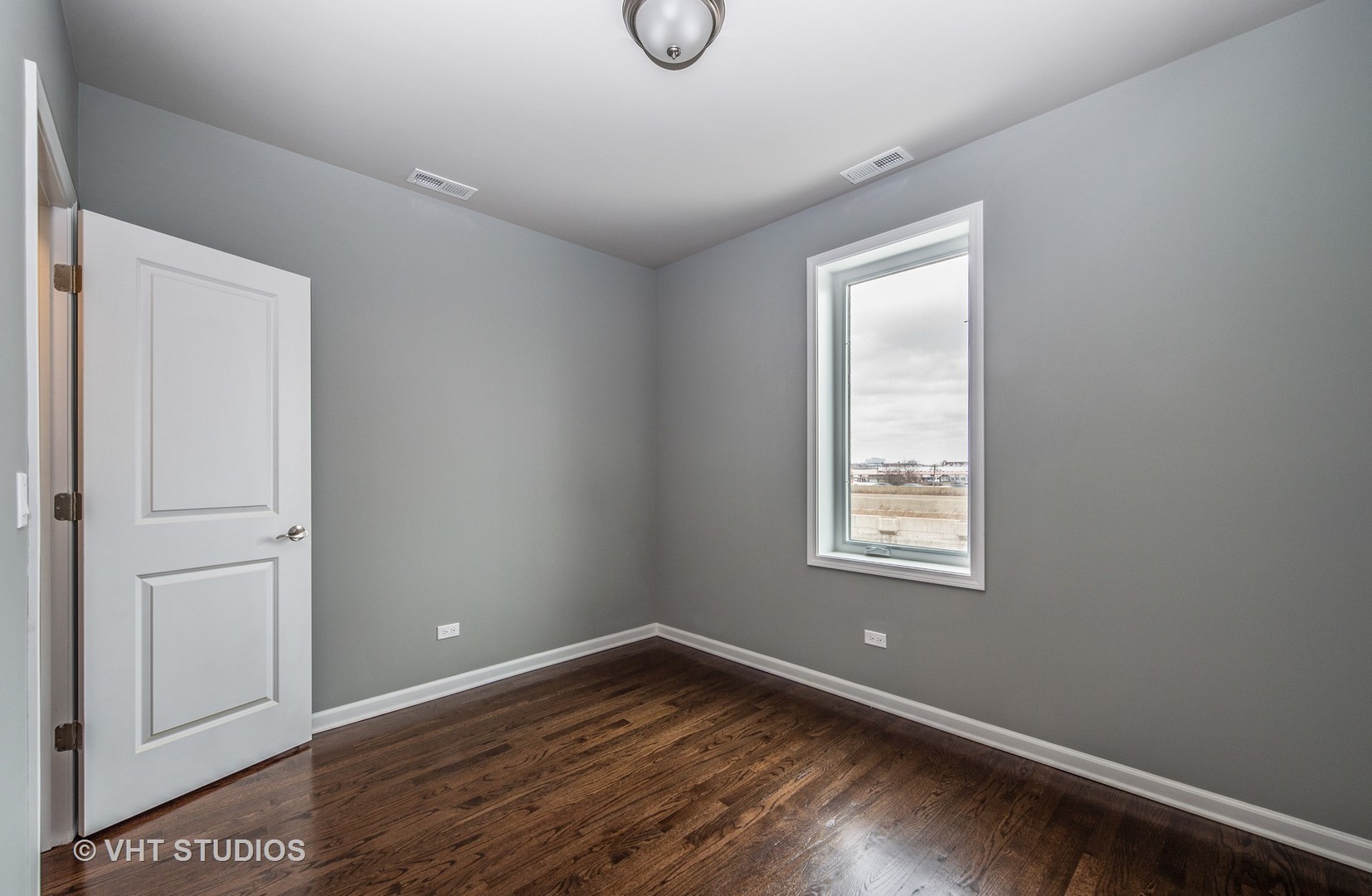 2606 South Halsted Street, Unit 2N Chicago, IL 60608 - Photo 8 of 10 a view of an empty room with wooden floor and window