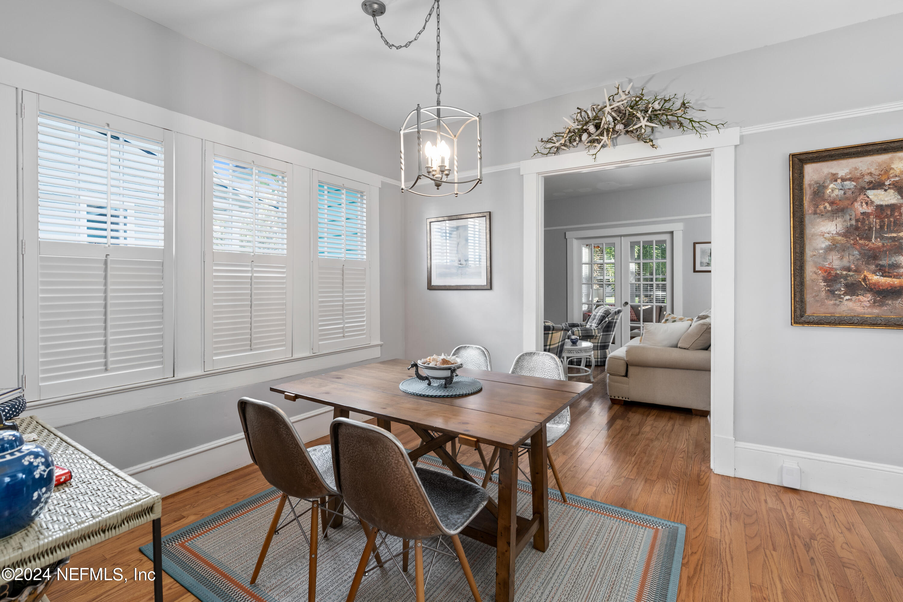 34 Park Avenue St. Augustine, FL 32084 - Photo 12 of 37 a view of a dining room with furniture wooden floor and a chandelier