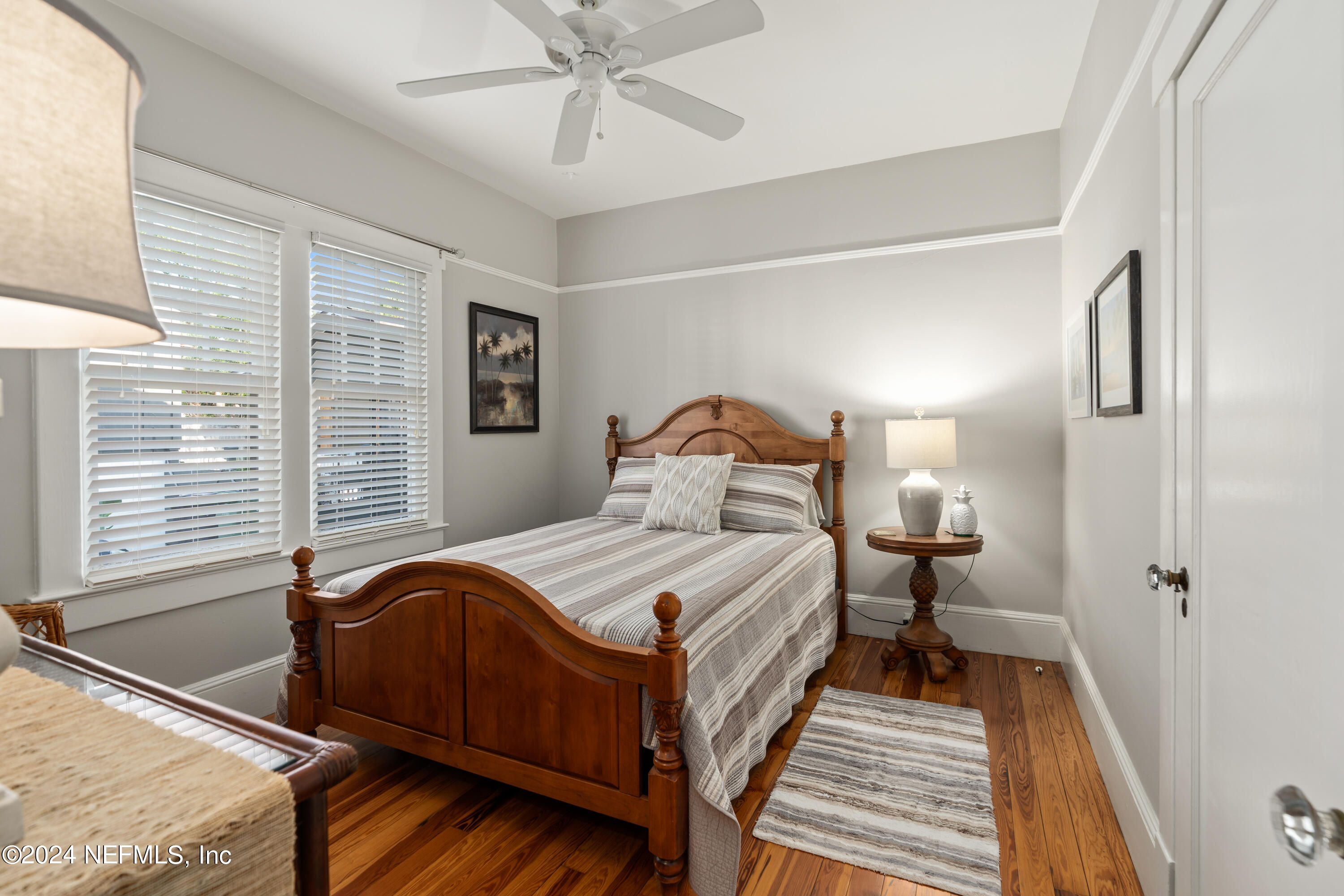 34 Park Avenue St. Augustine, FL 32084 - Photo 21 of 37 a bedroom with a bed and wooden floor