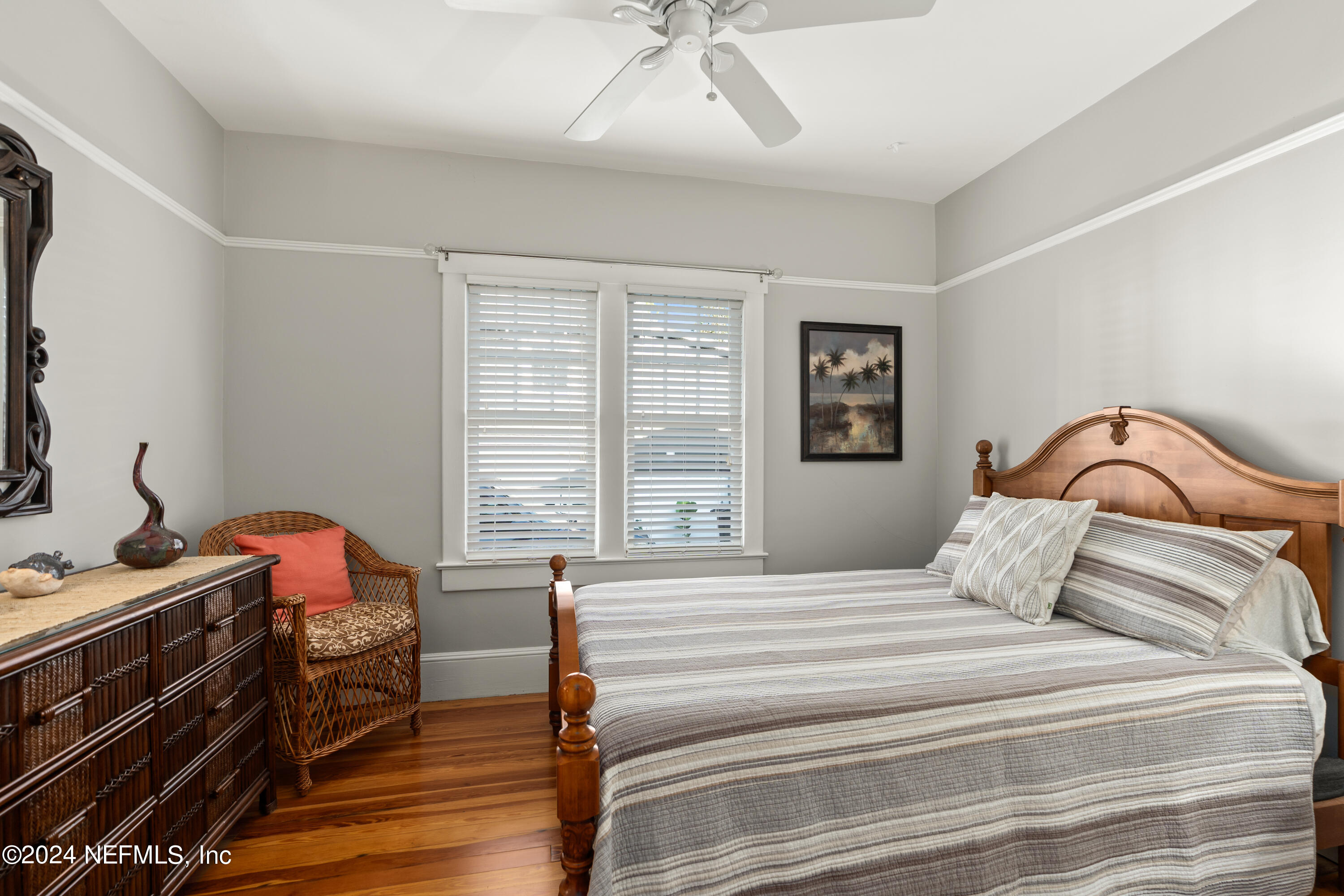 34 Park Avenue St. Augustine, FL 32084 - Photo 22 of 37 a bedroom with a bed and a chandelier