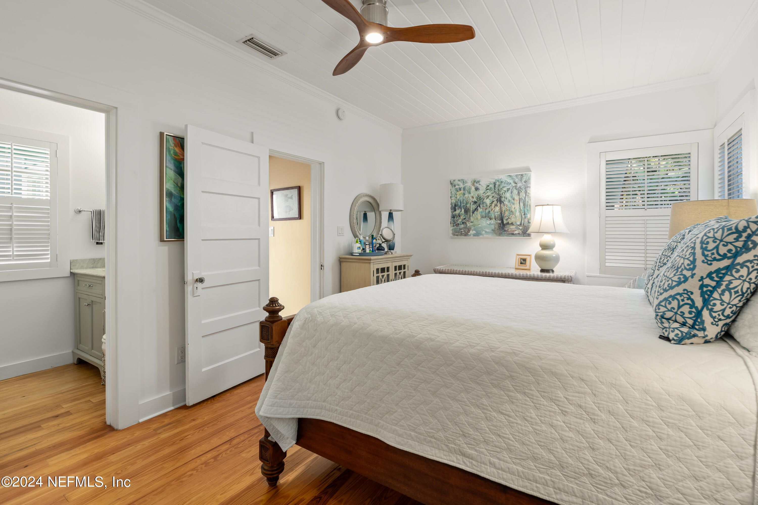 34 Park Avenue St. Augustine, FL 32084 - Photo 25 of 37 a bedroom with a bed and wooden floor
