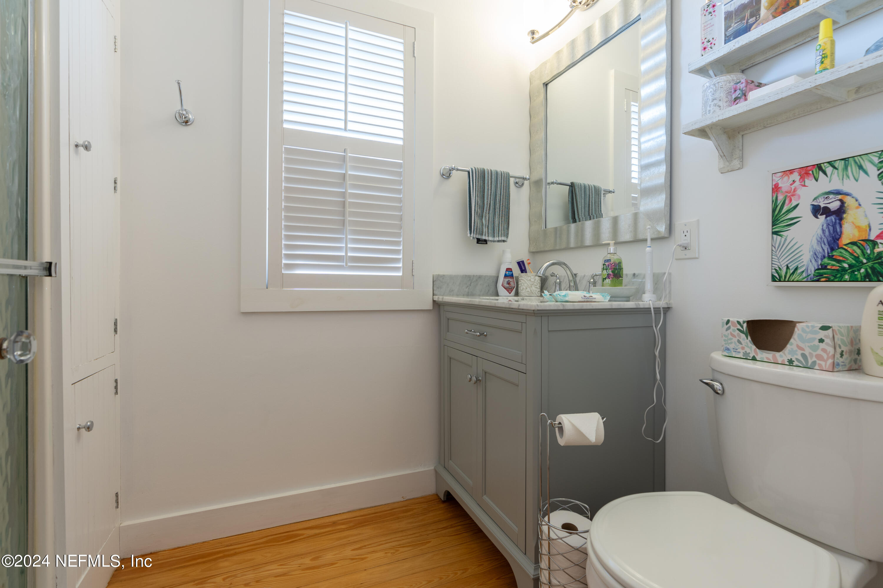 34 Park Avenue St. Augustine, FL 32084 - Photo 26 of 37 a bathroom with a toilet a sink a window and mirror