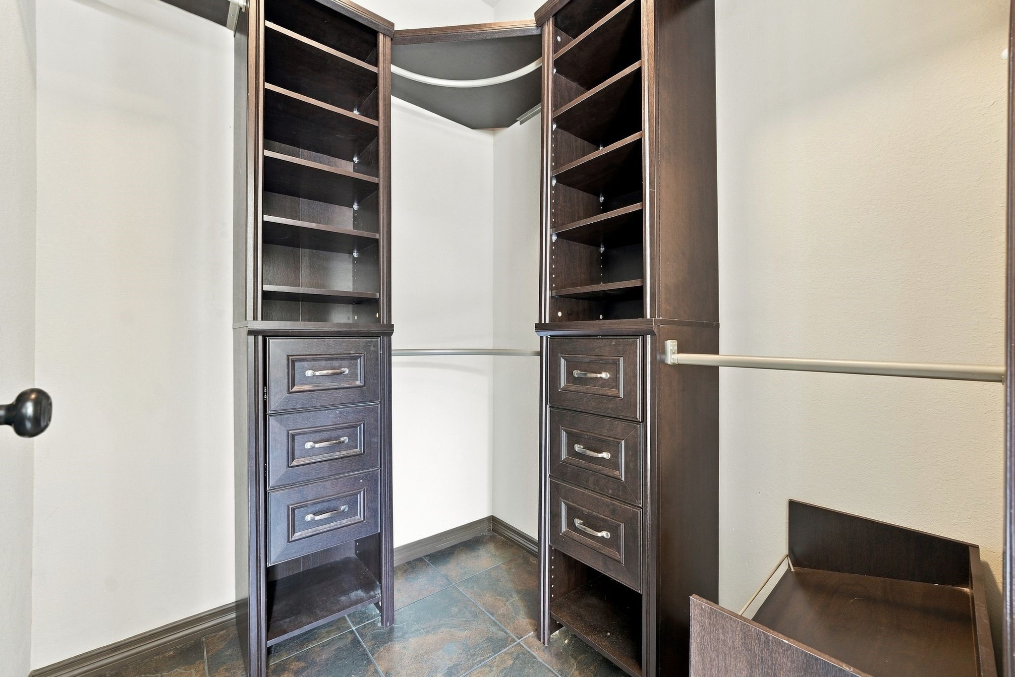 7049 Pine Shadows Road Cleveland, TX 77328 - Photo 22 of 49 One of the spacious walk-in closets featuring custom dark wood shelving and ample hanging space for organized storage.