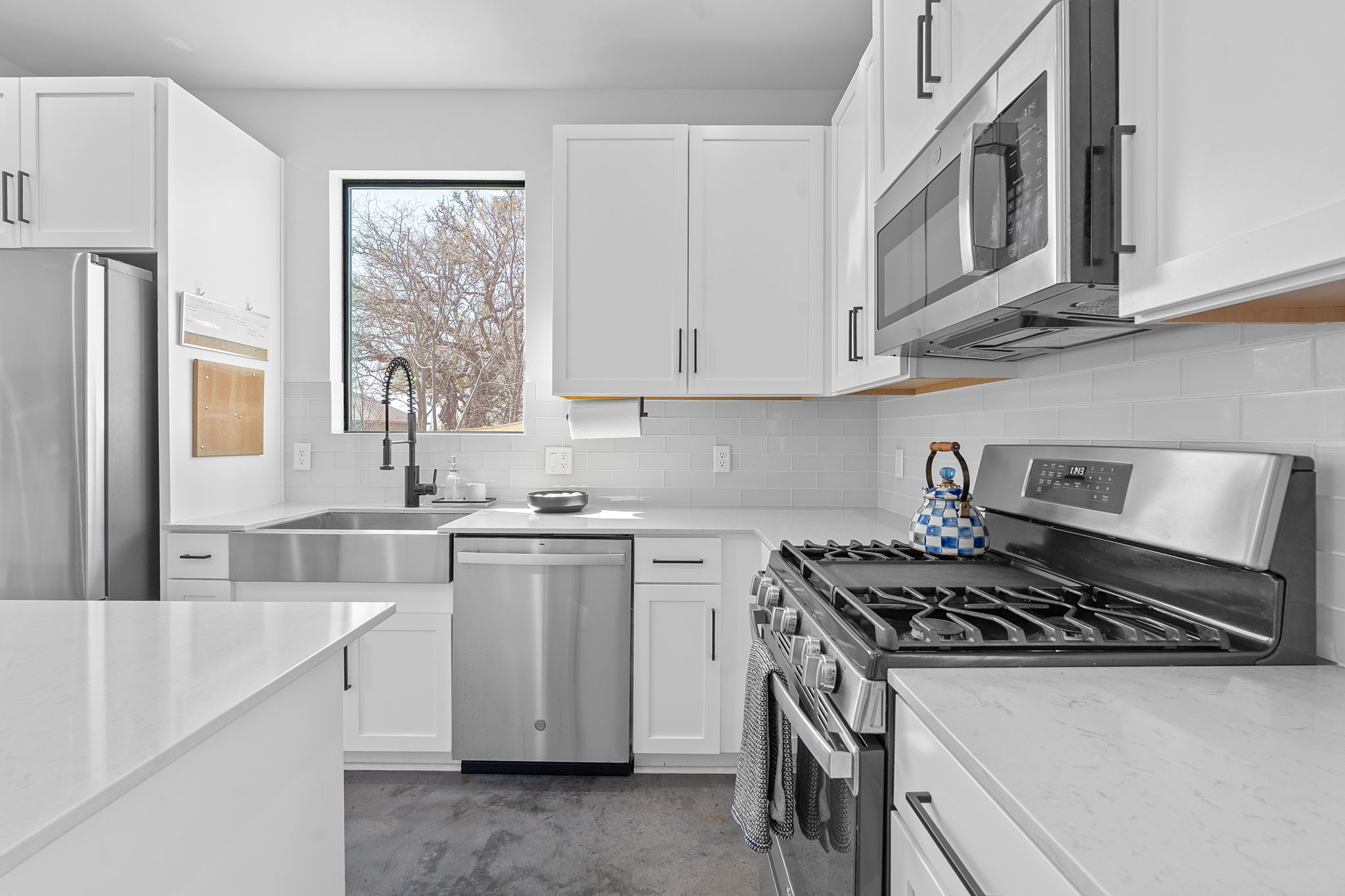 1168 Ridgeway Drive, Unit 2 Austin, TX 78702 - Photo 8 of 25 a kitchen with stainless steel appliances granite countertop a stove and a refrigerator