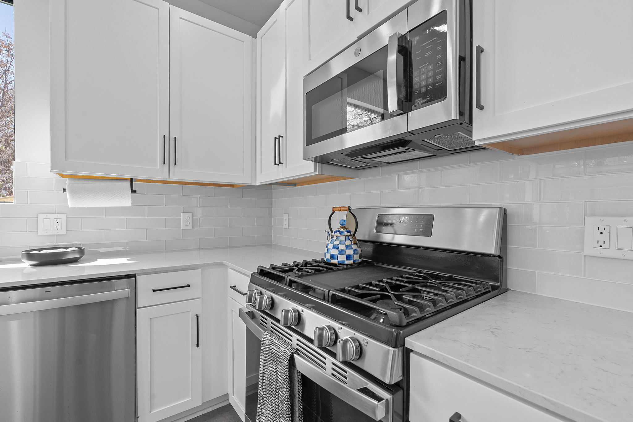 1168 Ridgeway Drive, Unit 2 Austin, TX 78702 - Photo 9 of 25 a kitchen with stainless steel appliances granite countertop white cabinets a stove a sink and dishwasher