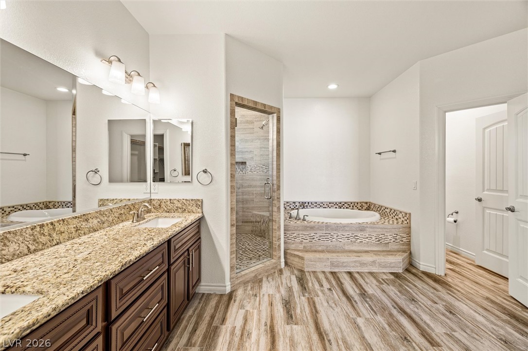 6720 Stubblefield Drive Pahrump, NV 89061 - Photo 28 of 51 Luxurious bathing retreat boasts a dual vanity, separate shower, and a deeply set soaking tub.