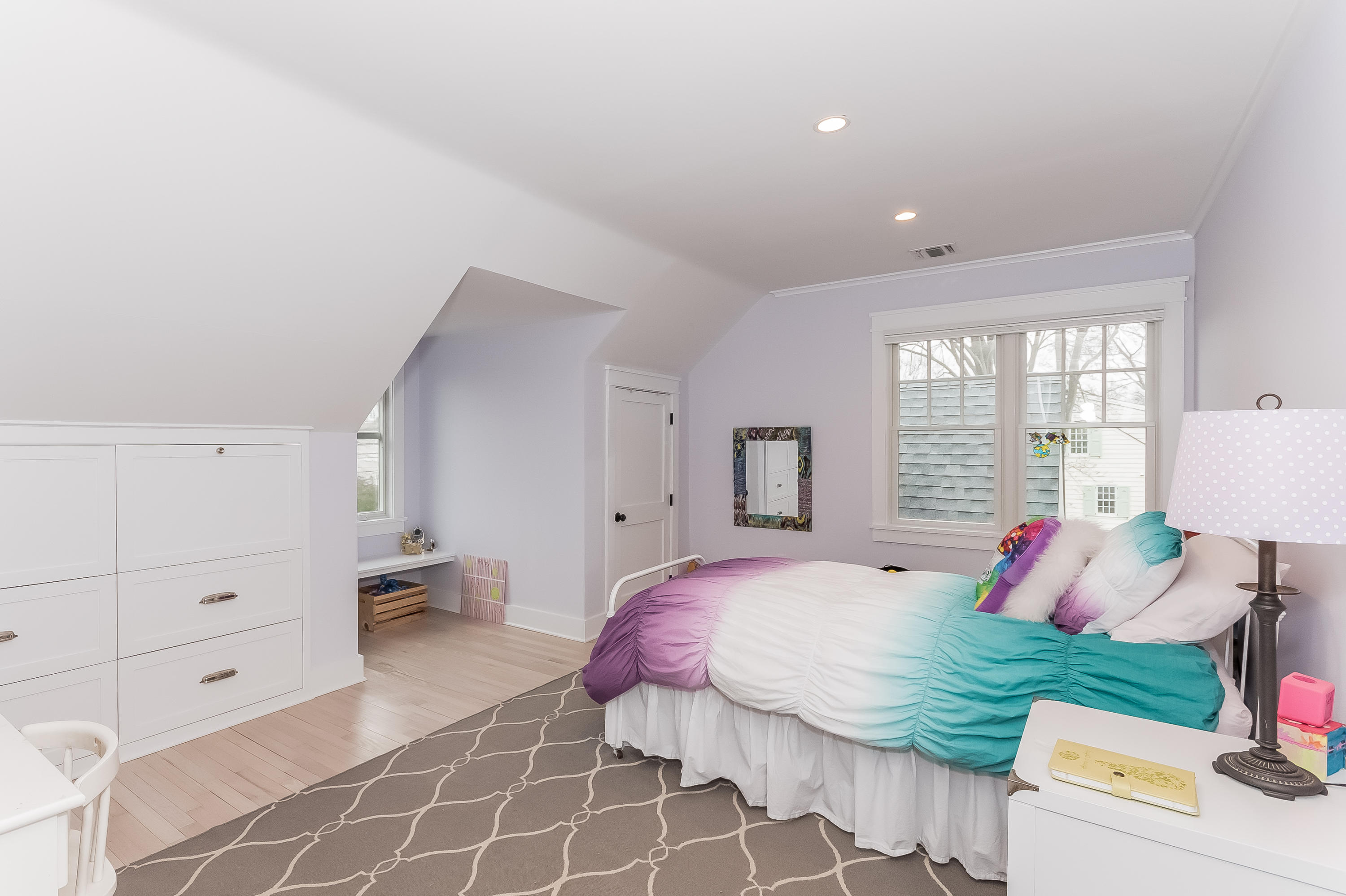 20 Plymouth Road Darien, CT 06820 - Photo 25 of 46 a spacious bedroom with a bed and a lamp on dresser