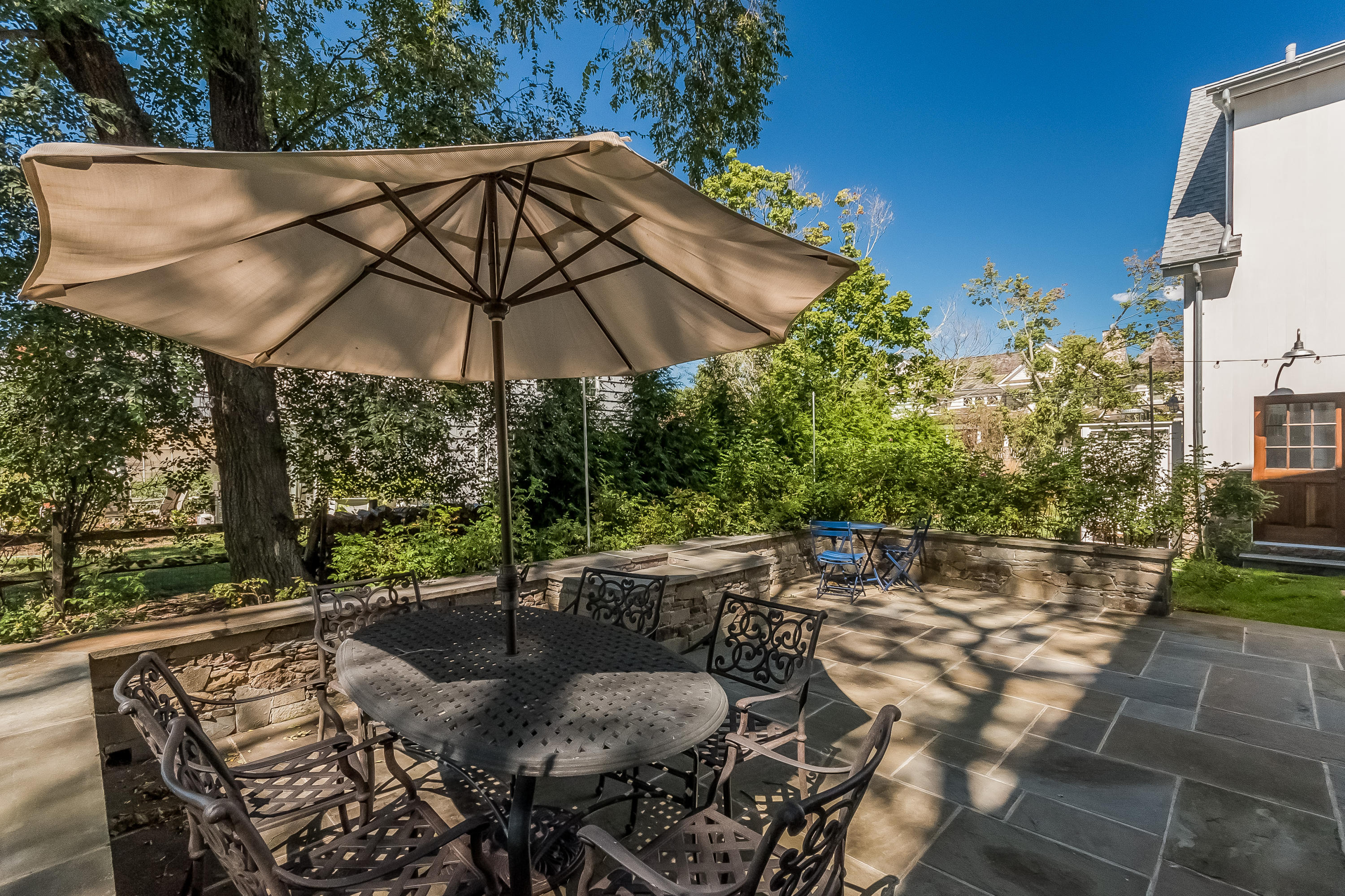 20 Plymouth Road Darien, CT 06820 - Photo 30 of 46 a view of patio with chairs and table under an umbrella