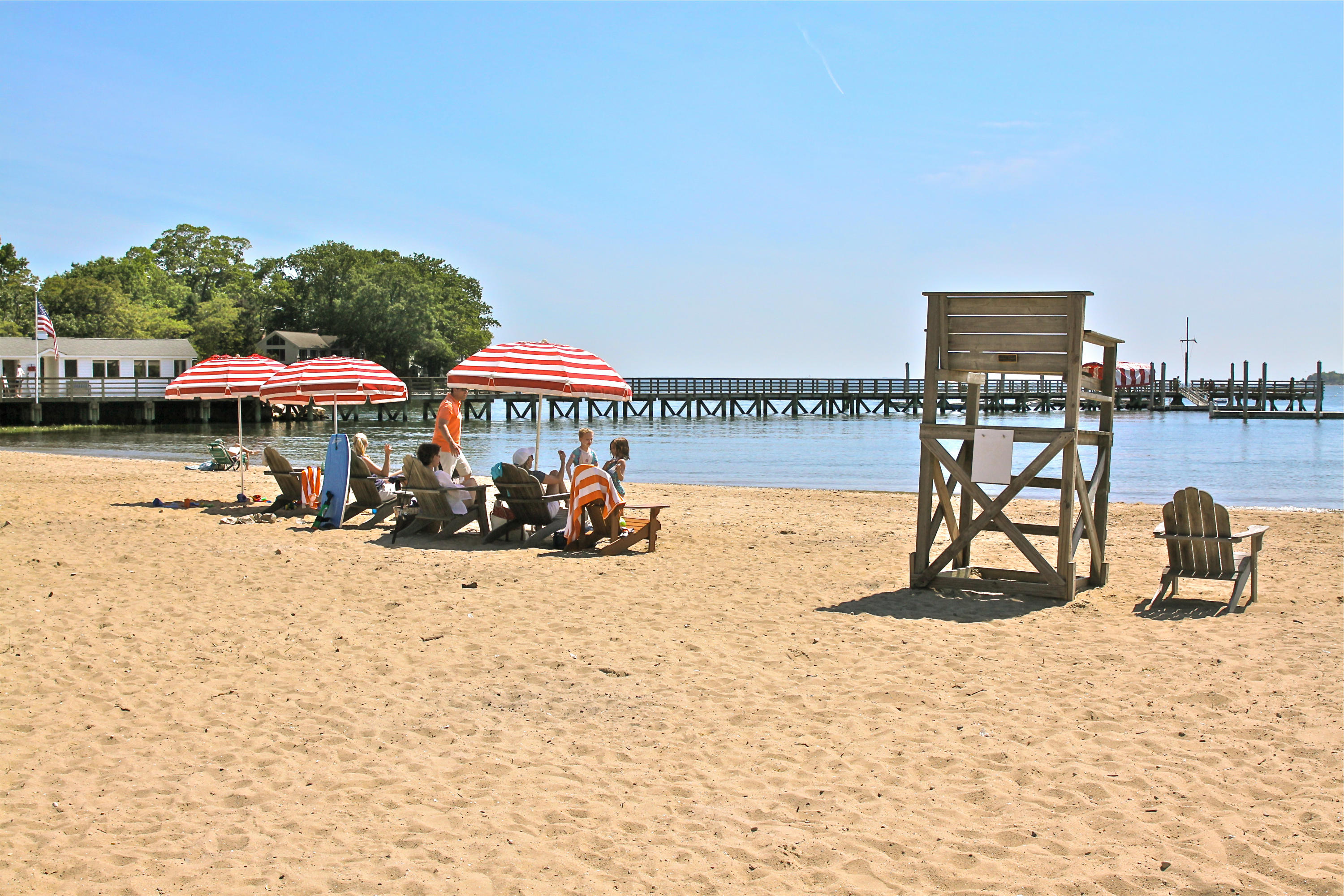 20 Plymouth Road Darien, CT 06820 - Photo 42 of 46 a view of a lake with a table and chairs under an umbrella