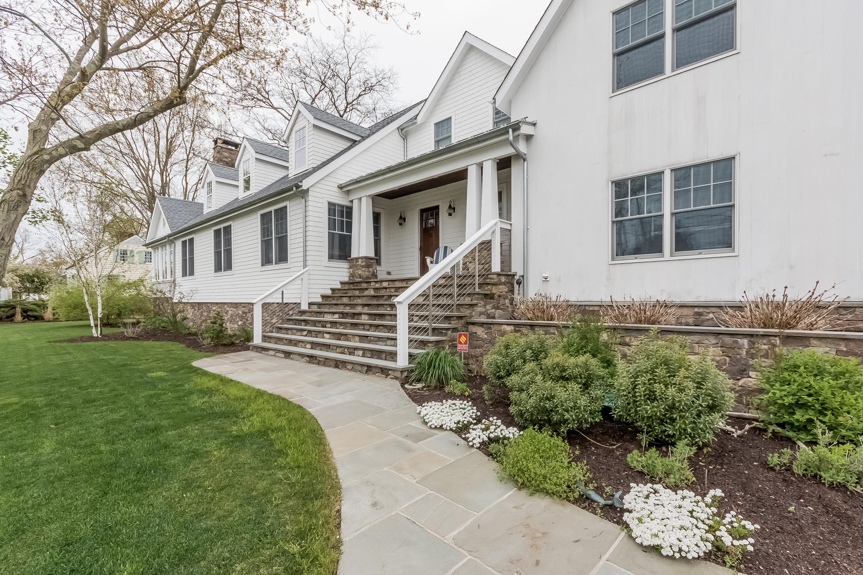 20 Plymouth Road Darien, CT 06820 - Photo 6 of 46 a front view of a house with a garden