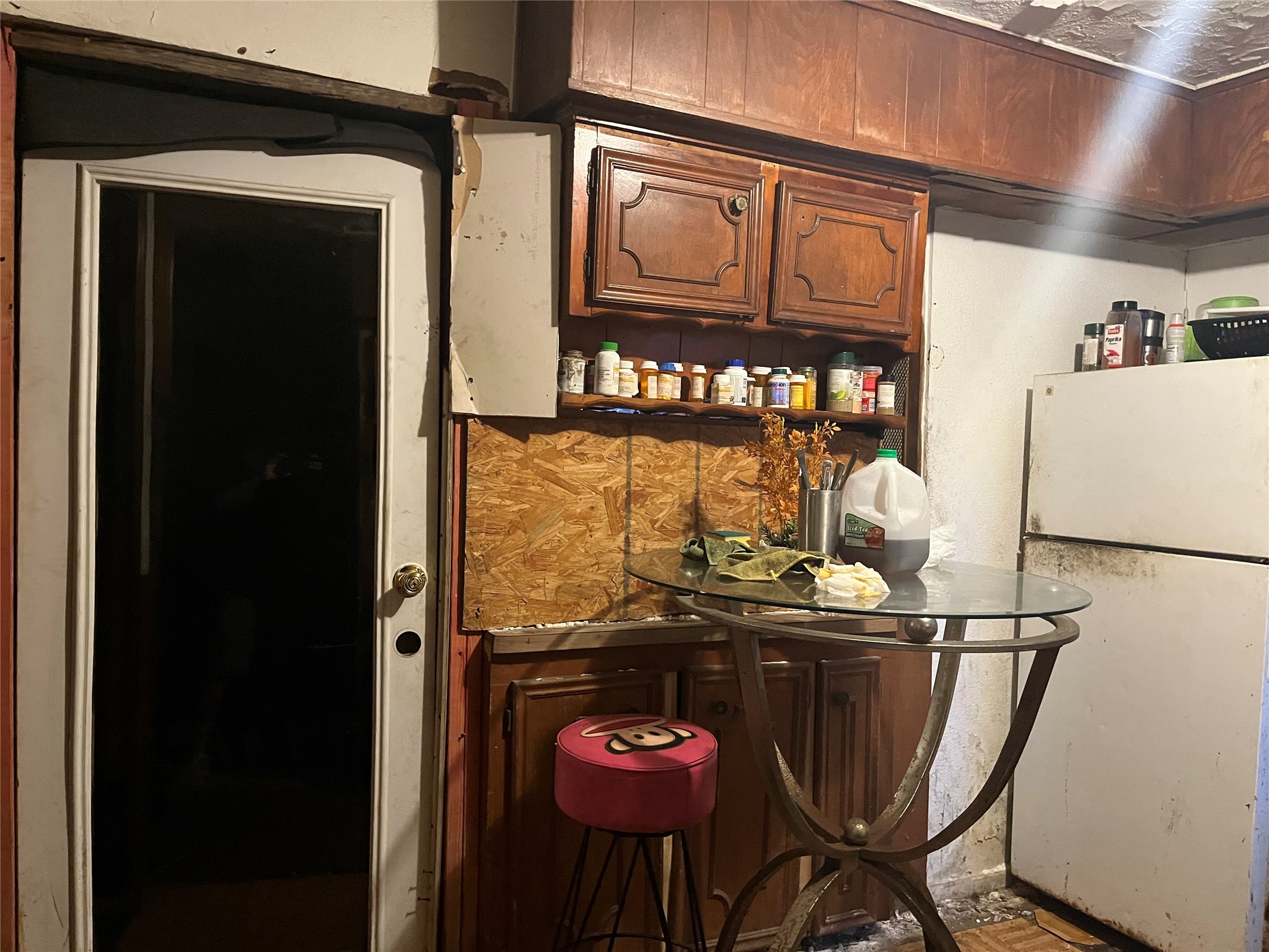 8016 Munn Street Houston, TX 77029 - Photo 19 of 24 a kitchen with a refrigerator and cabinets
