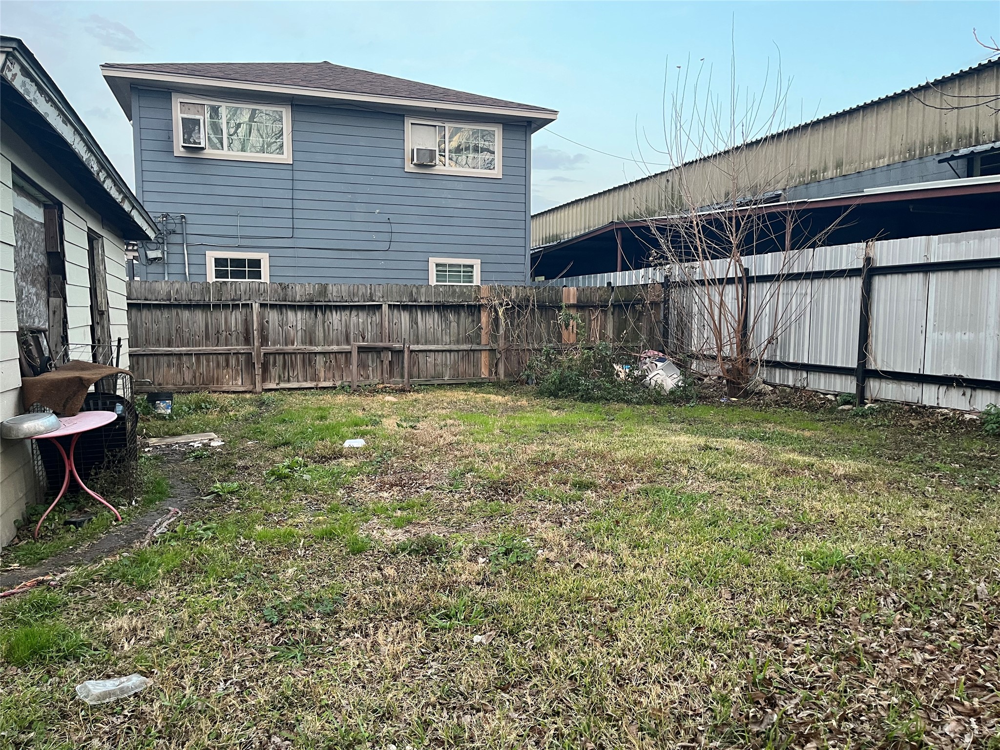 8016 Munn Street Houston, TX 77029 - Photo 3 of 24 a view of a backyard with a small cabin and chair