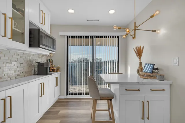 a kitchen with stainless steel appliances granite countertop a sink and a refrigerator