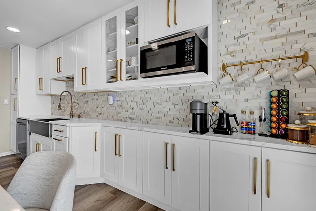a kitchen with stainless steel appliances granite countertop a sink and a microwave