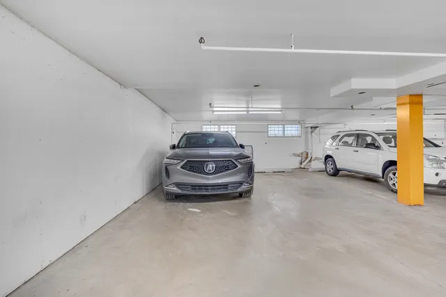 a view of parking garage with cars parked