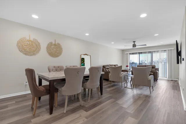 a view of a dining room with furniture and wooden floor