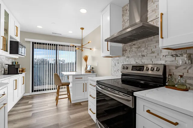 a kitchen with a stove and a wooden cabinets