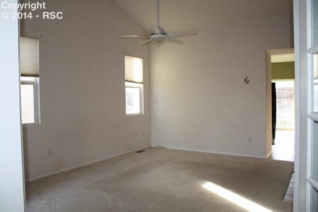 7714 Old Spec Road Peyton, CO 80831 - Photo 3 of 15 Great Room with Vaulted Ceiling & Ceiling Fan