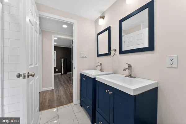 a bathroom with a sink vanity and a mirror