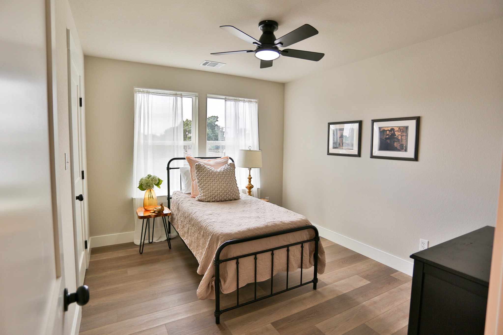 325 String Prairie Way Smithville, TX 78957 - Photo 21 of 23 a bedroom with a bed and a chandelier
