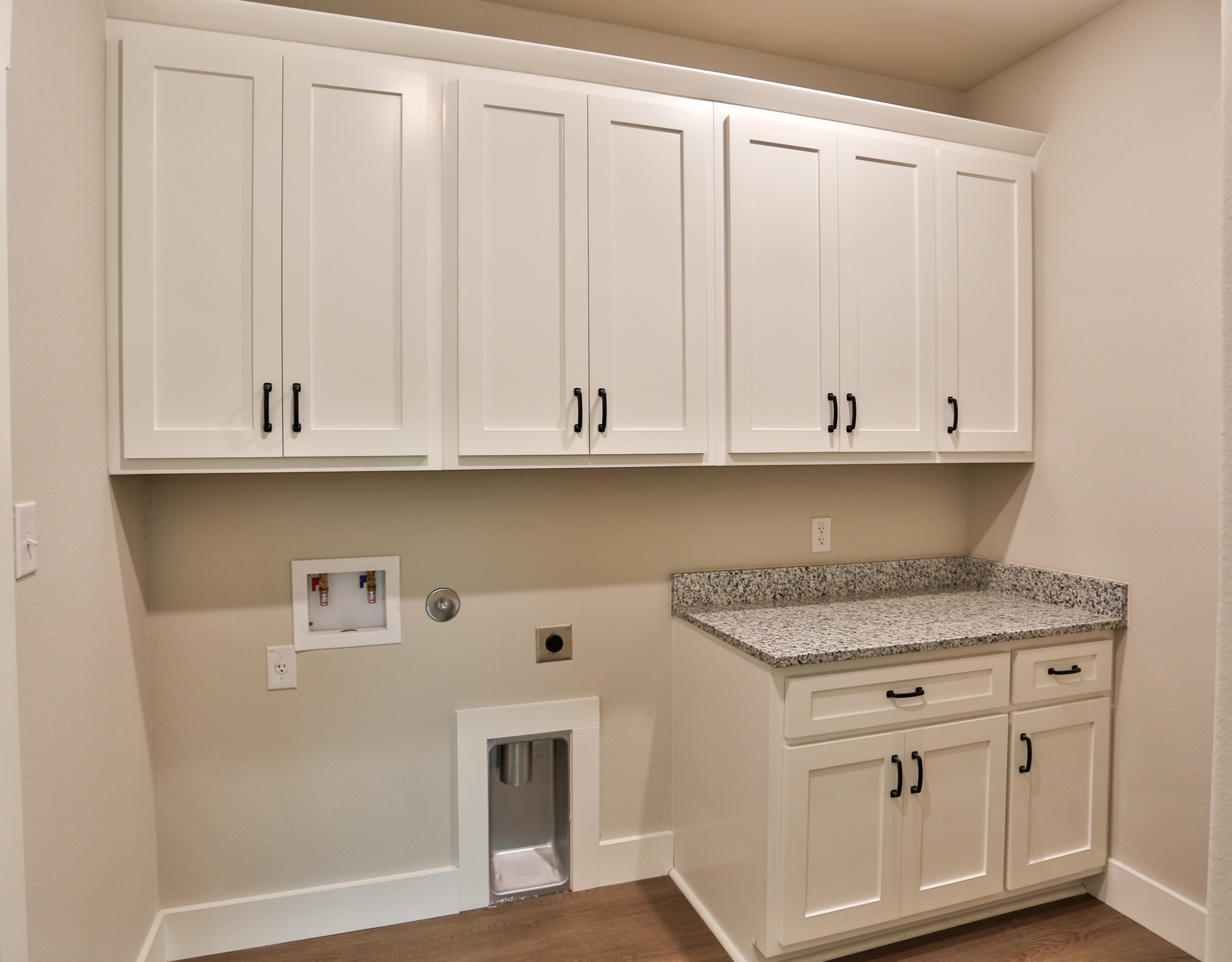 325 String Prairie Way Smithville, TX 78957 - Photo 10 of 23 a kitchen with granite countertop white cabinets and a sink