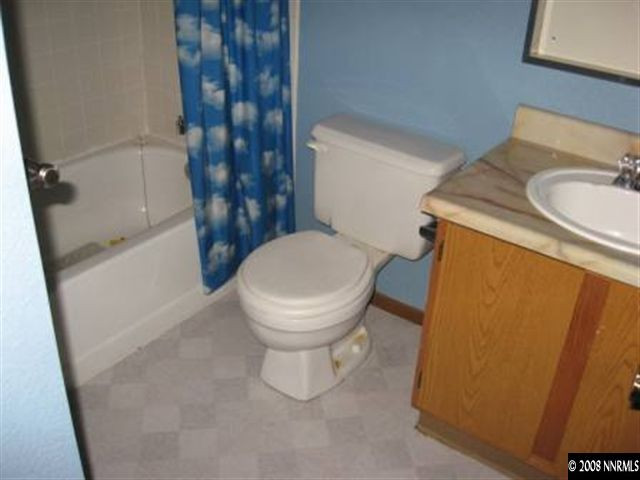 3390 Becard Lane Reno, NV 89508 - Photo 5 of 7 a white toilet sitting next to a sink