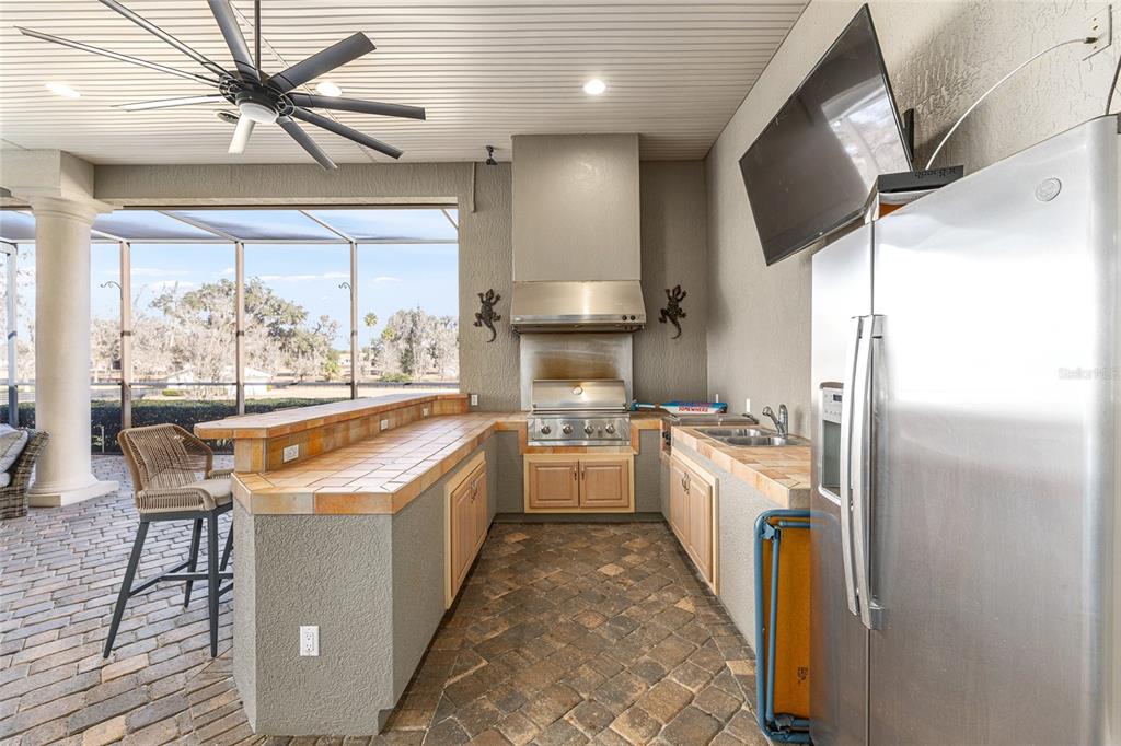 9389 Southwest 14th Avenue Ocala, FL 34476 - Photo 27 of 59 a kitchen with stainless steel appliances granite countertop a refrigerator a sink dishwasher a stove and a dining table with wooden floor