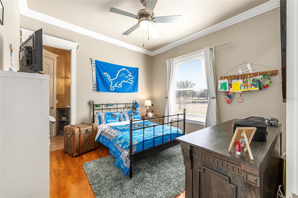 9389 Southwest 14th Avenue Ocala, FL 34476 - Photo 35 of 59 a bedroom with a bed and wooden floor