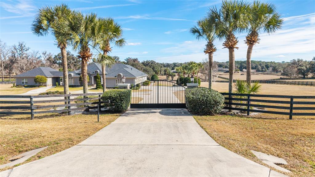 9389 Southwest 14th Avenue Ocala, FL 34476 - Photo 4 of 59 a view of a swimming pool with a patio and a yard