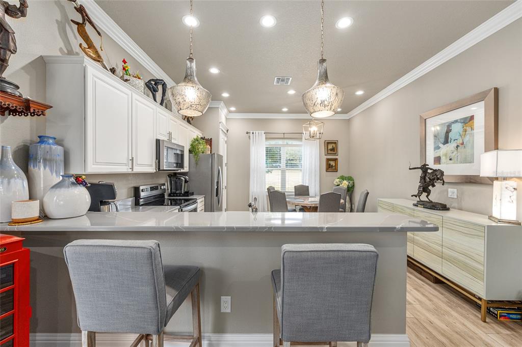 9389 Southwest 14th Avenue Ocala, FL 34476 - Photo 45 of 59 a kitchen with kitchen island granite countertop a sink cabinets and window