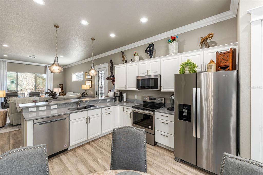 9389 Southwest 14th Avenue Ocala, FL 34476 - Photo 50 of 59 a kitchen with stainless steel appliances a stove refrigerator sink and microwave