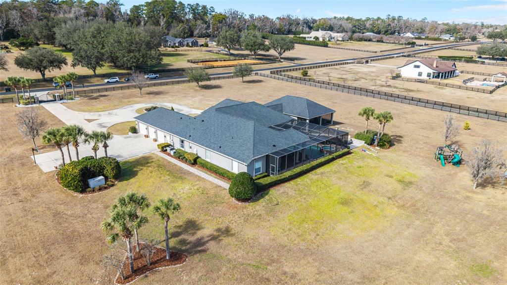 9389 Southwest 14th Avenue Ocala, FL 34476 - Photo 58 of 59 a view of a swimming pool with a lawn chairs under an umbrella