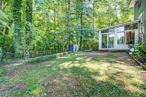 a view of a house with backyard and garden