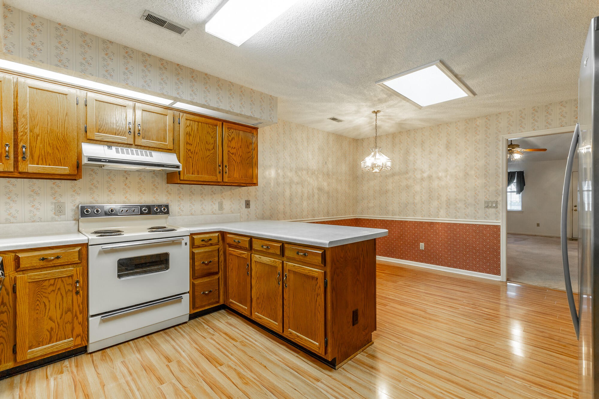 6780 Hickory Creek Road Chattanooga, TN 37421 - Photo 12 of 60 a kitchen with stainless steel appliances granite countertop a sink a stove and a refrigerator