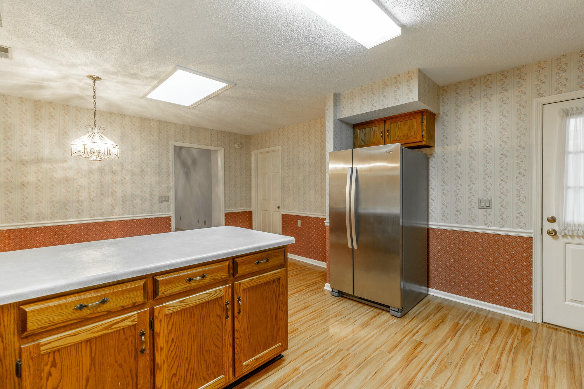 6780 Hickory Creek Road Chattanooga, TN 37421 - Photo 13 of 60 a room with kitchen island a wooden floor and refrigerator