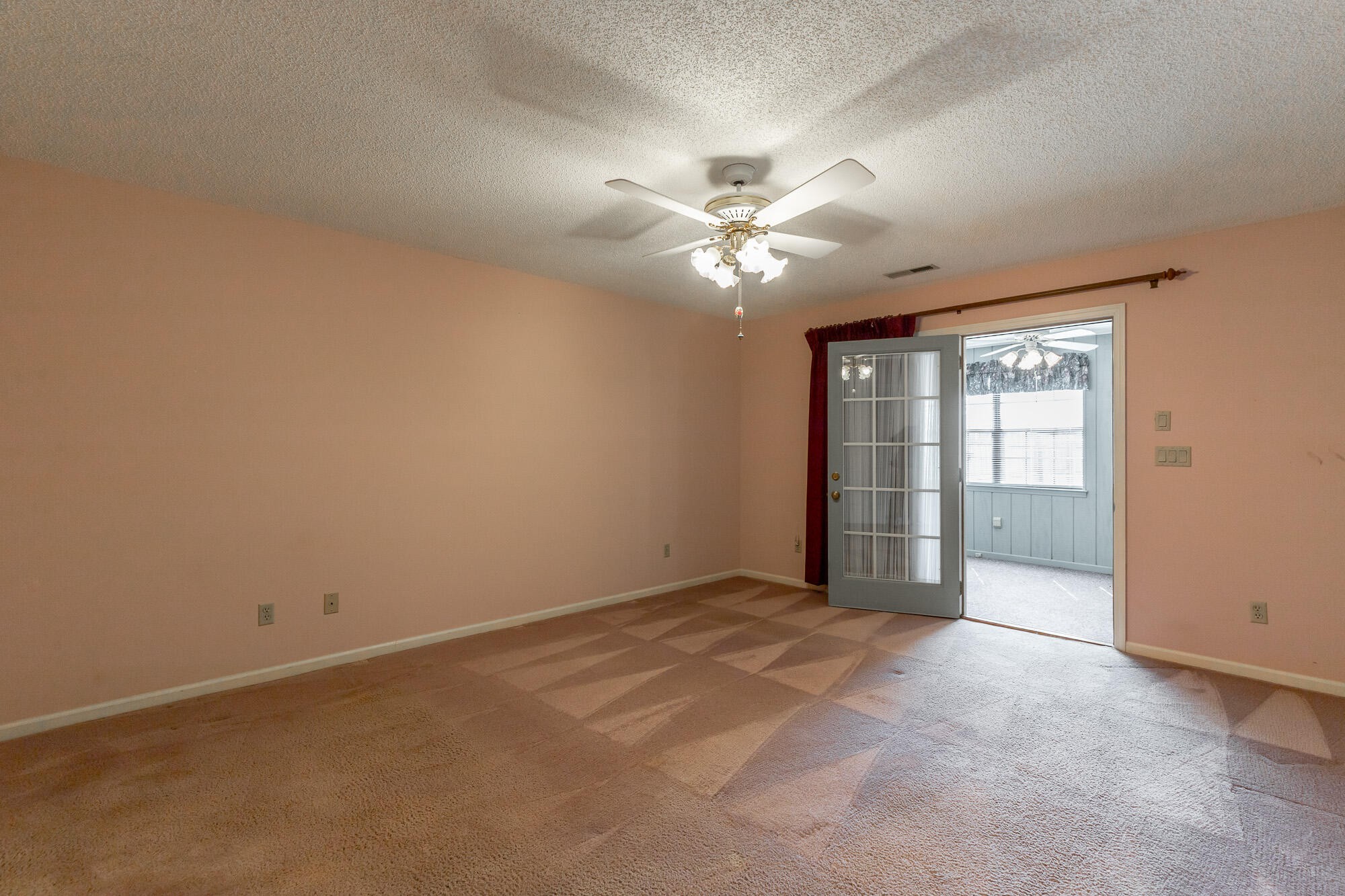 6780 Hickory Creek Road Chattanooga, TN 37421 - Photo 29 of 60 an empty room with chandelier fan and windows