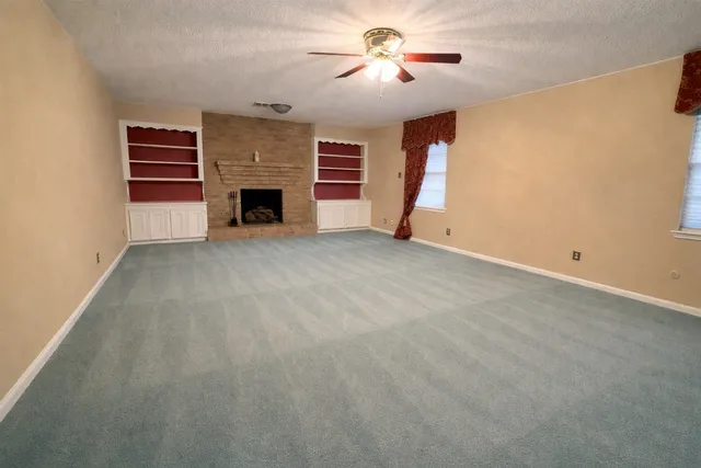 a view of empty room with a fireplace