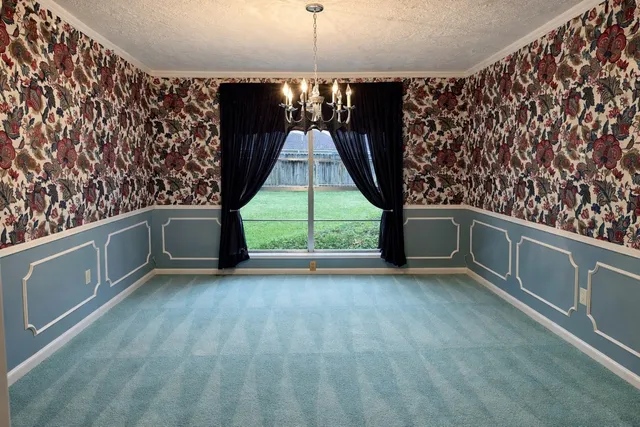 a view of an empty room with a fireplace and a window