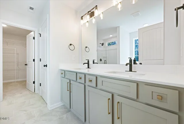 a spacious bathroom with a double vanity sink mirror and shower